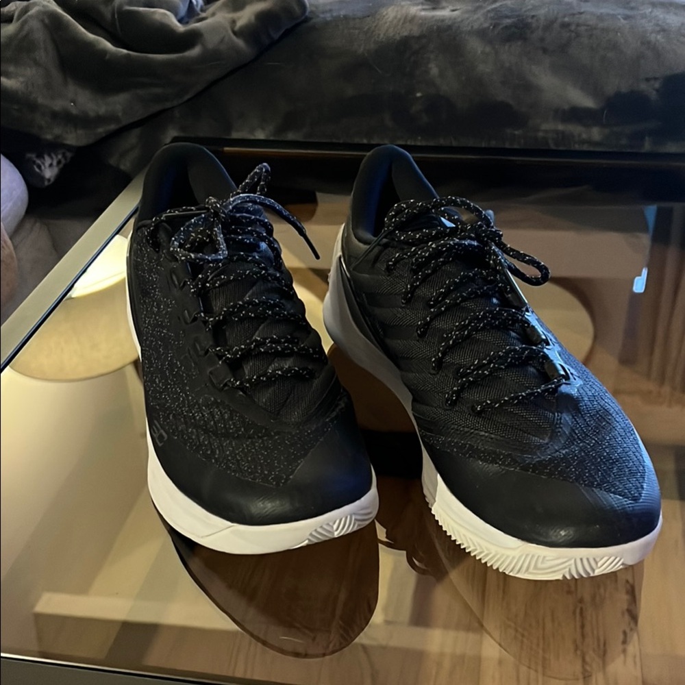 Men's Black Steph Curry Under Armour sneakers.